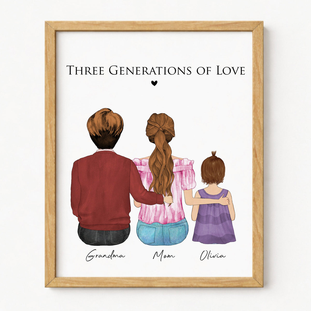 A framed art print featuring a watercolor illustration of a family of three seen from behind, with the text 'THREE GENERATIONS OF LOVE' above and names 'Grandma', 'Mom', and 'Olivia' below. The print is housed in a light natural wood frame and displayed against a clean white wall.