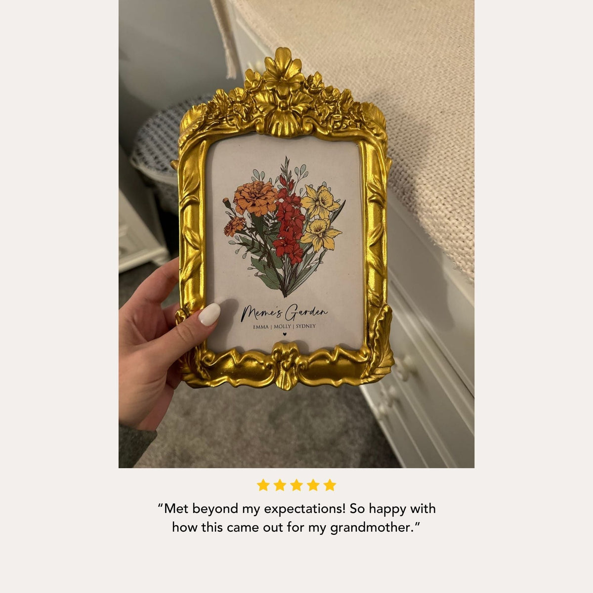 A hand holding a gold-framed picture of a floral arrangement, with a caption expressing happiness and appreciation for the gift.